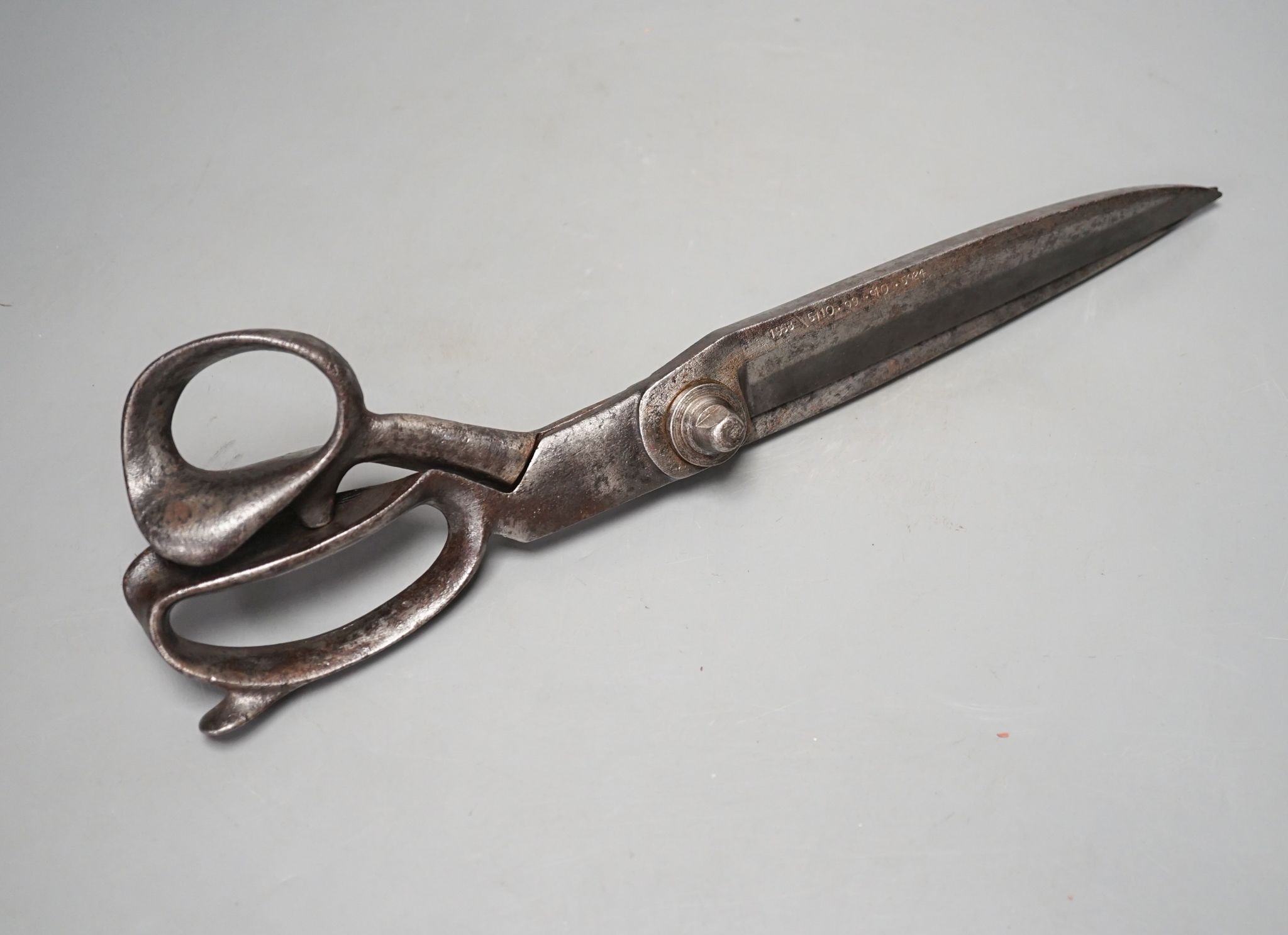 A pair of over-sized tailor’s scissors, one blade stamped ‘1938 \ 5110.99.910.5934’